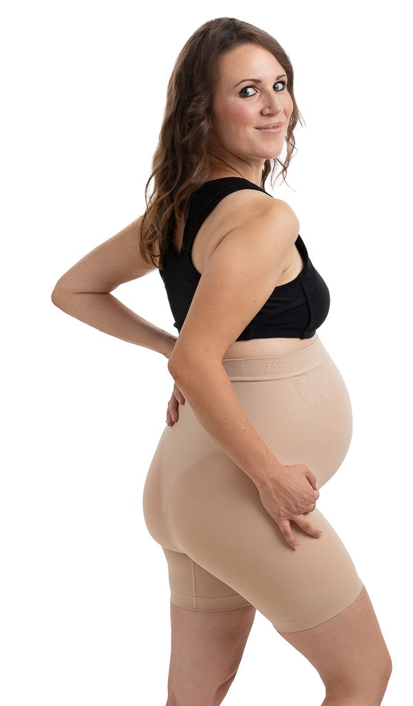 Premium Photo  Close up of pregnant woman in underwear wearing supporting  bandage and showing okay gesture at green background with copy space.  orthopedic abdominal support belt concept.